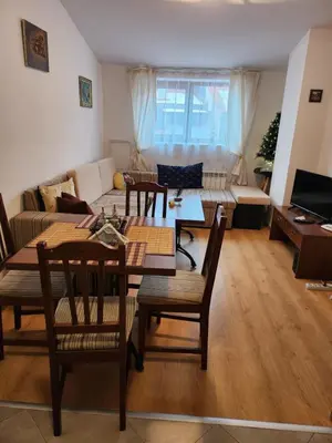 a living room with a table and a couch at Mountain paradise apartment in Bansko