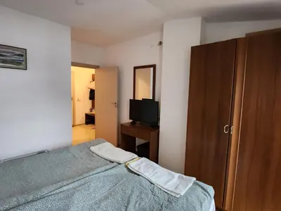 a bedroom with a bed and a dresser and a television at Mountain paradise apartment in Bansko