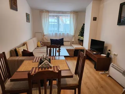 a living room with a couch and a table at Mountain paradise apartment in Bansko