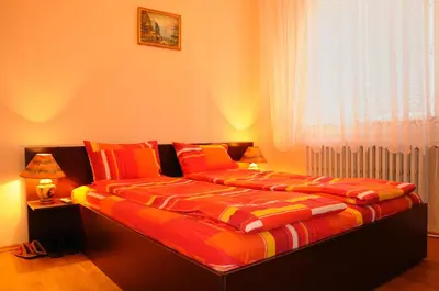 a bedroom with a bed with orange and red sheets at Sakutski House in Hisarya