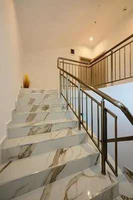 a staircase with marble steps and a railing at Sakutski House in Hisarya