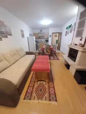 a living room with a couch and a table at Апартамент 9 in Pamporovo