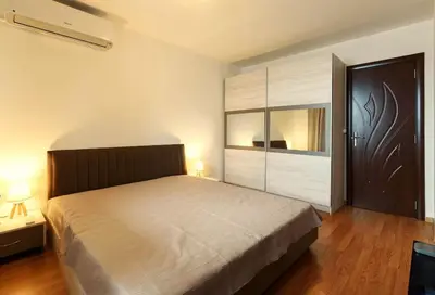 a bedroom with a large bed and a large closet at Bansko Ski & Relax Apartment in Bansko