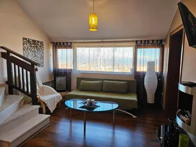 a living room with a couch and a table at Ioannis Apartment Bansko in Bansko