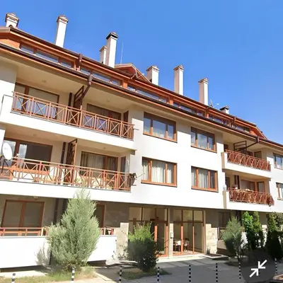 a large white building with balconies on it at Ioannis Apartment Bansko in Bansko
