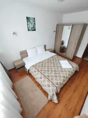 a bedroom with a bed with a large mirror at Belvedere Holiday Club SPA&POOL Private Apartments in Bansko