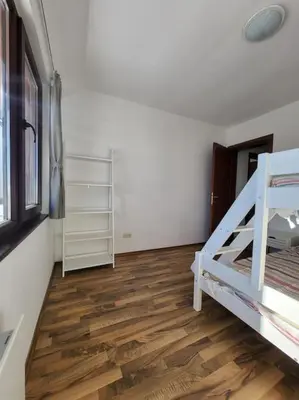 a room with a bunk bed and a wooden floor at KS Rooftop 180° in Bansko