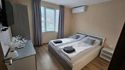 a bedroom with a bed with two bags on it at Вила Доброво in Dobrovo