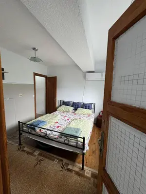 a bedroom with a bed in a room at Apartment sunny morning in Sandanski