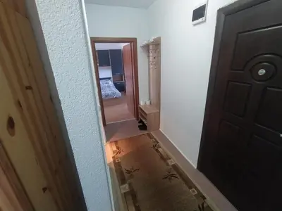 an empty hallway with a door and a mirror at Apartment sunny morning in Sandanski