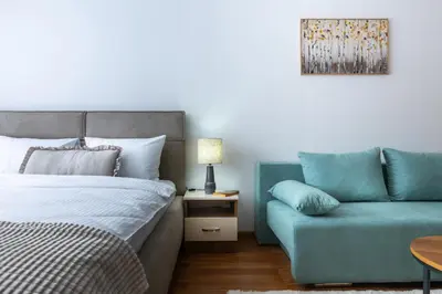 a bedroom with a bed and a couch at Pirin Sense Apartment Complex in Bansko