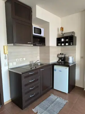 a small kitchen with a sink and a stove at Happy Stay 100mfrom Gondola with free Bottle of Wine and free Parking in Bansko