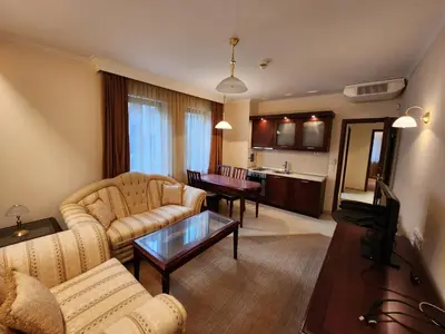 a living room with a couch and a table at Luxury Downtown Appartment - 150m ski lift Gondola in Bansko