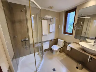a bathroom with a shower and a toilet and a sink at Luxury Downtown Appartment - 150m ski lift Gondola in Bansko