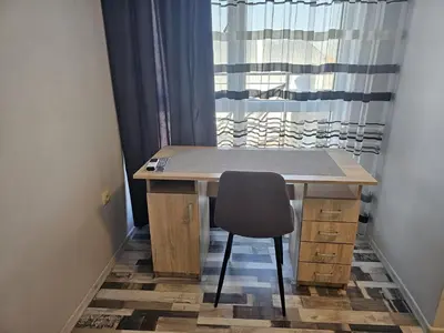 a desk with a chair in front of a window at Studio Apartament 47А- Trakia 54 А in Plovdiv