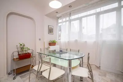 a dining room with a glass table and chairs at Cozy Apartment near Vitosha Street by Flat Mаnager in Sofia