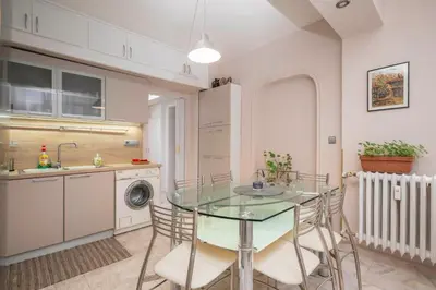 a kitchen with a glass table and chairs and a sink at Cozy Apartment near Vitosha Street by Flat Mаnager in Sofia