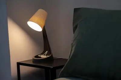 a lamp sitting on a table next to a bed at Vintage Home by NDK and Vitosha Blvd with Free Secured Parking in Sofia