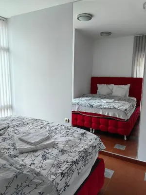 a bedroom with a bed with a red headboard at 2 Bedrooms apartment. in Plovdiv