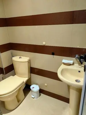 a bathroom with a toilet and a sink at 2 Bedrooms apartment. in Plovdiv
