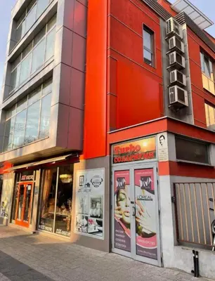 a building on a street with a store at 2 Bedrooms apartment. in Plovdiv