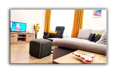 a living room with a couch and a tv at Teo and Miki 612 in Pamporovo