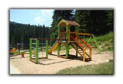 a playground with a slide in the sand at Teo and Miki 612 in Pamporovo