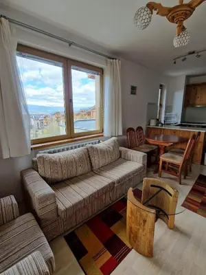a living room with a couch and a table at Saint John Hill Apartment in Bansko