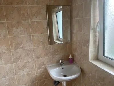 a bathroom with a sink and a mirror at ЛАЗАРОВИ in Hisarya