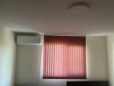 a window in a room with a red curtain at ЛАЗАРОВИ in Hisarya