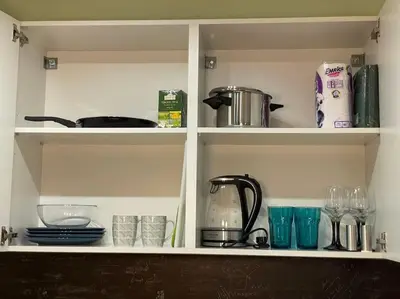 a kitchen shelf with dishes and utensils on it at Sweet Studio Office & Amazing Coffee in Sofia