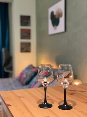 two wine glasses sitting on top of a wooden table at Sweet Studio Office & Amazing Coffee in Sofia