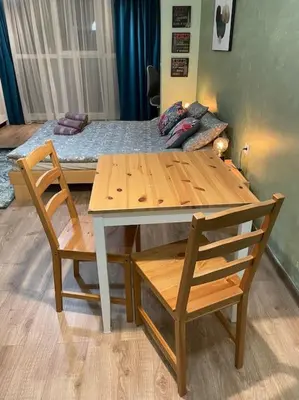 a table and chairs with a bed in a room at Sweet Studio Office & Amazing Coffee in Sofia