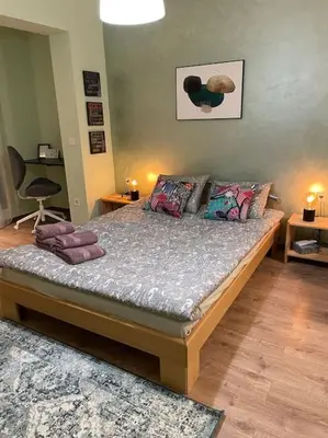 a bedroom with a bed with pillows on it at Sweet Studio Office & Amazing Coffee in Sofia