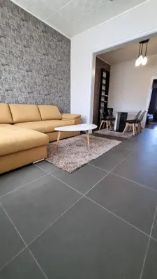 a living room with a couch and a table at Central Apartment in Sofia