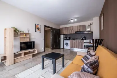 a living room with a couch and a kitchen at Cozy Homes 2 in Sofia