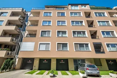 a building with a car parked in front of it at Cozy Homes 2 in Sofia