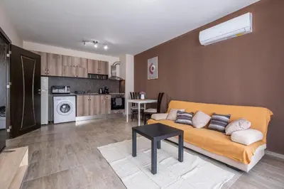 a living room with a couch and a kitchen at Cozy Homes 2 in Sofia