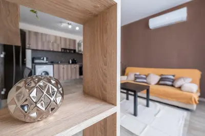 two pictures of a living room and a kitchen at Cozy Homes 2 in Sofia