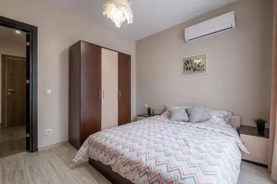 a bedroom with a bed and a chandelier at Cozy Homes 3 in Sofia