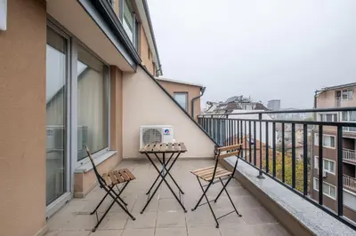 a balcony with two chairs and a air conditioner on it at Cozy Homes 3 in Sofia