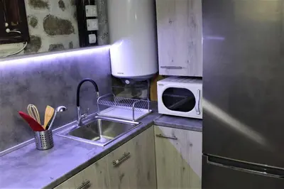 a kitchen with a sink and a stainless steel refrigerator at Villa Fest in Bansko