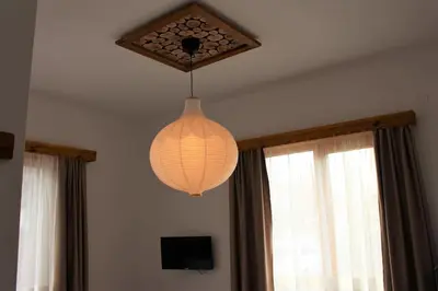 a chandelier hanging from a ceiling in a room at Villa Fest in Bansko
