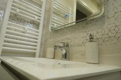 a white bathroom with a sink and a mirror at View in Petrich
