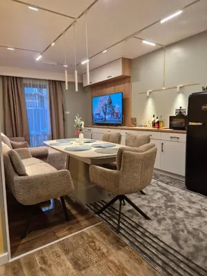 a kitchen and dining room with a table and chairs at Bansko Getaway- Ski & Summer Activities , sleep 6 in Bansko