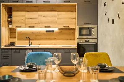 a kitchen with a table with wine glasses on it at Luxury 2 Bedroom Apartment - Private Garden in Sofia