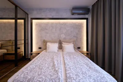 a bedroom with a large white bed with two pillows at Luxury 2 Bedroom Apartment - Private Garden in Sofia