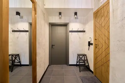 a hallway with a door and two bar stools at Luxury 2 Bedroom Apartment - Private Garden in Sofia