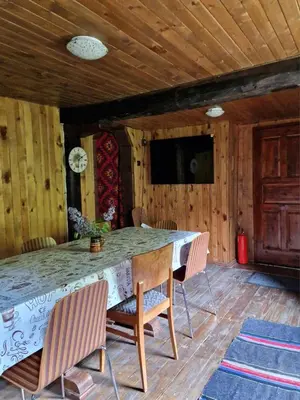 a dining room with a table with chairs and a television at Vila Anna in Ribarica