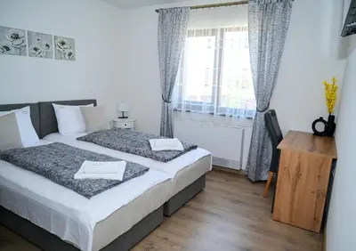 a bedroom with two beds and a window at КЪЩА ЗА ГОСТИ ГРОШЪ in Dobrinishte